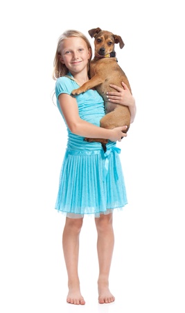Young Girl in Light Blue Dress Holding her Dogの写真素材