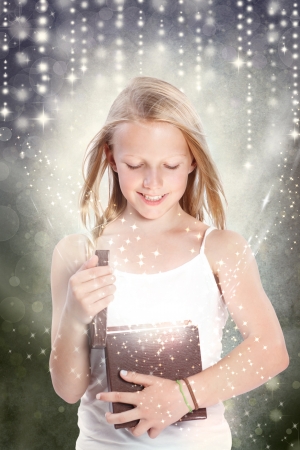 Happy Young Blonde Girl Opening a Gift Boxの写真素材
