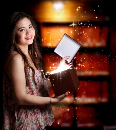 Happy Young Woman Opening a Gift Boxの写真素材