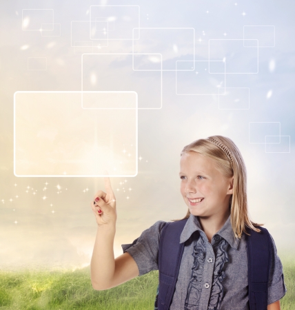 Young Blonde Girl Looking and Pointing at Your Product or Conceptの写真素材