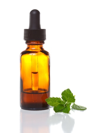 Herbal medicine dropper bottle with mint leavesの写真素材