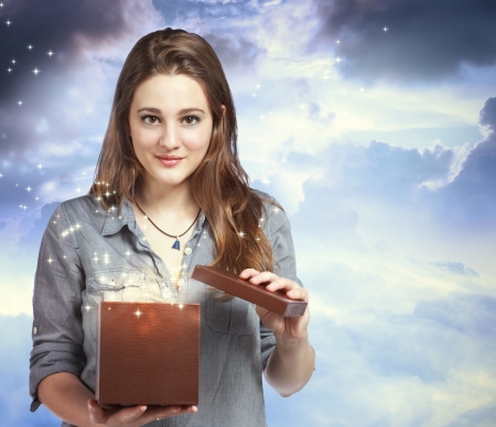 Beautiful Young Woman Opening a Gift Boxの写真素材