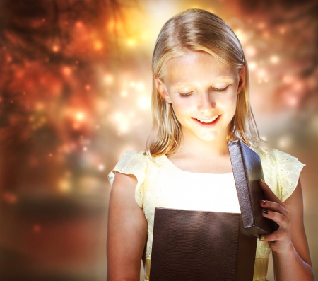 Happy Blonde Girl Opening a Present Boxの写真素材