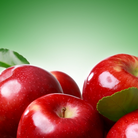 Fresh apples on green soft green backgroundの写真素材