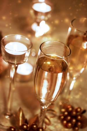Sparkling champagne glasses with candles の写真素材