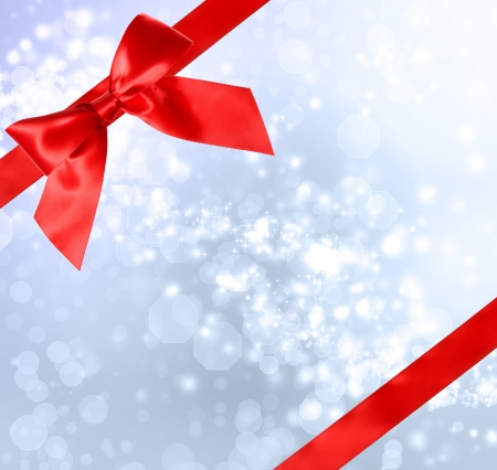 Red Bow and Ribbon with Blue Bokeh Lights Background の写真素材