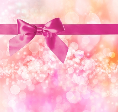Pink Bow and Ribbon with Pink Bokeh Lights Background の写真素材