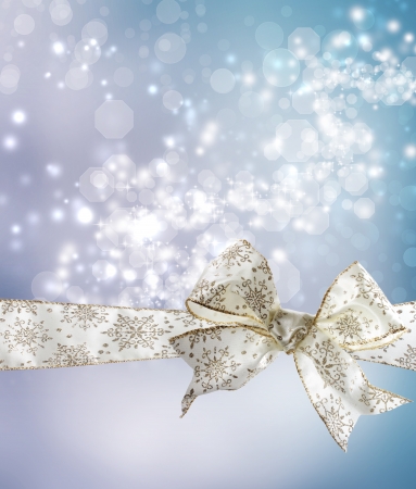 White Snowflake Bow and Ribbon with Bokeh Lights Background の写真素材