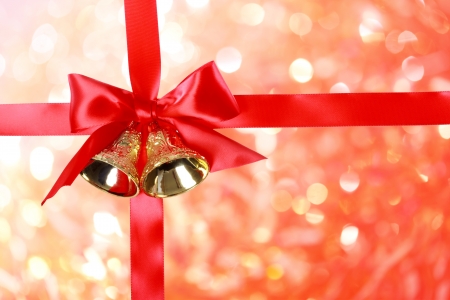 Red Christmas Ribbon with Bells over Christmas Abstract Lightsの写真素材