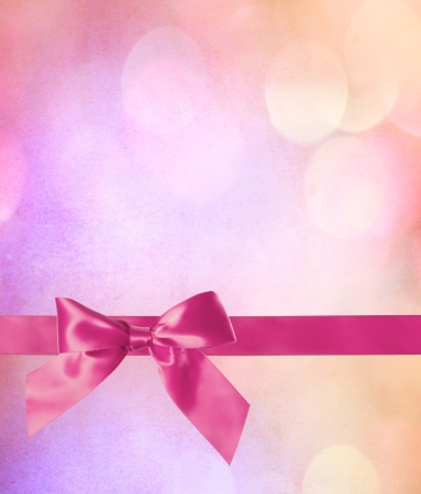 Pink Bow and Ribbon with Abstract Lights Background の写真素材