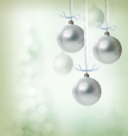 Christmas snowflake ornaments over soft green lights backgroundの写真素材