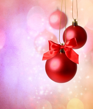Christmas red ornaments over pink  lights backgroundの写真素材