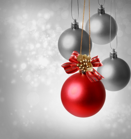 Christmas red ornaments over silver lights backgroundの写真素材