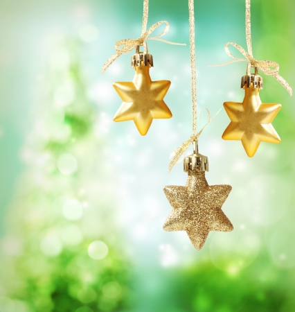 Christmas star ornaments over green tree lights backgroundの写真素材