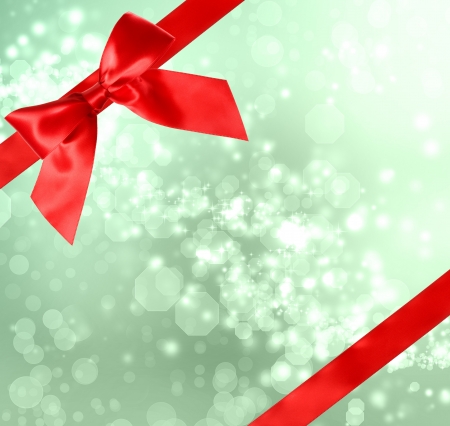 Red Bow and Ribbon with Green Bokeh Lights の写真素材