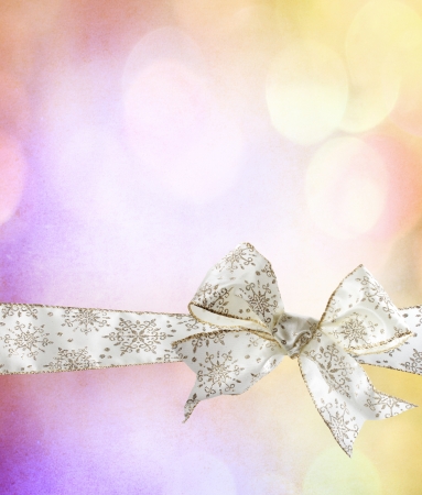 White Snowflake Bow and Ribbon with Abstract Lights Background の写真素材