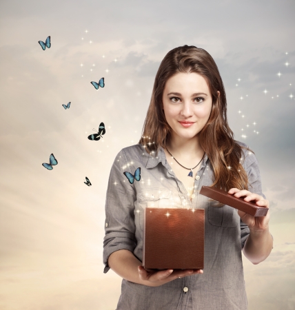 Girl Opening a Magical Giftbox with Butterfliesの写真素材