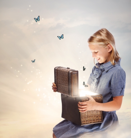 Happy Blond Girl Opening a Treasure Boxの写真素材