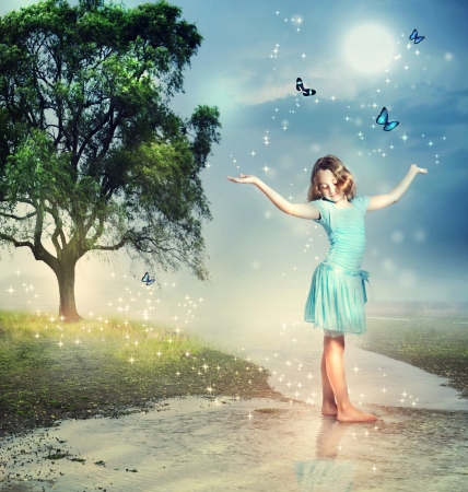 Happy Girl with Blue Butterflies at a Magical Brookの写真素材