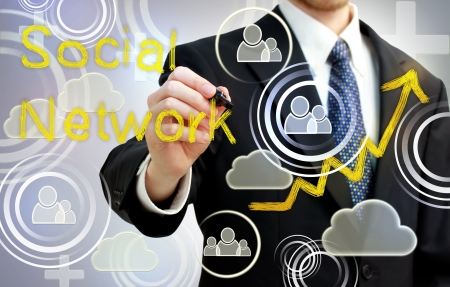 Businessman drawing social network with rising arrowsの写真素材