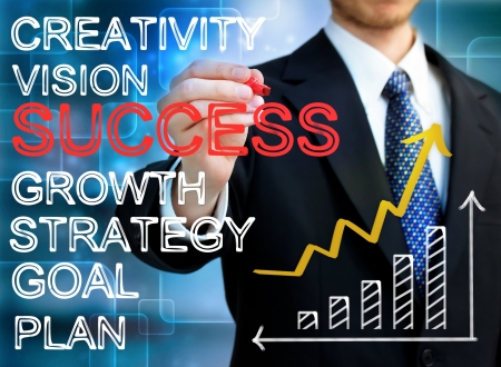 Businessman writing success concepts with rising arrow and bar graphの写真素材