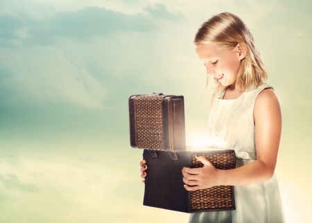 Happy Blonde Girl Opening a Treasure Boxの写真素材
