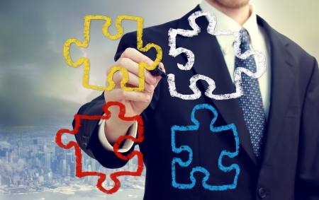 Businessman with puzzle pieces  - concepts of strategy, creativity, and teamworkの写真素材