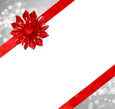 Red Bow and Ribbon with Silver Abstract Lights and White Background の写真素材