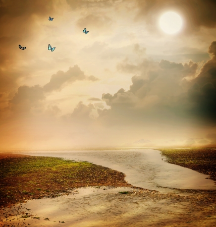 Butterflies and moon in sepia colored fantasy landscapeの写真素材