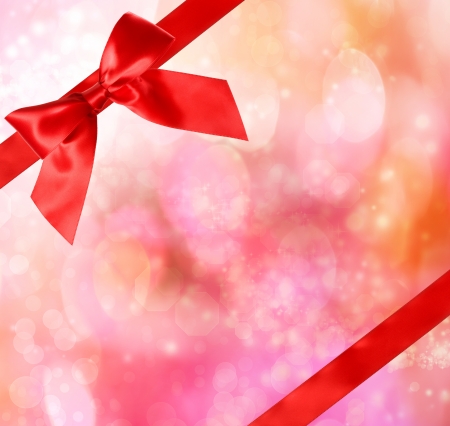 Red Bow and Ribbon with Magenta Bokeh Lights Background の写真素材