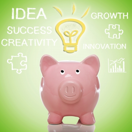 Pink Piggy Bank with Idea Light bulb with Handwriting Textsの写真素材