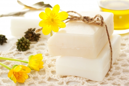 Bars of soap with yellow flowers and oilの写真素材