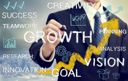 Business man with concepts of growth, innovation, vision, success, and creativity with rising arrowsの写真素材