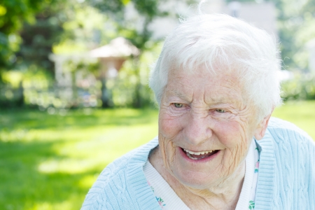 Portrait of a senior woman smiling in a blue sweater outsideの写真素材
