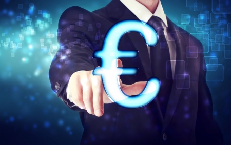 Businessman pointing Euro icon with blue tech backgroundの写真素材