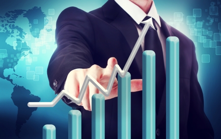 Businessman with graph representing growth  with world map backdropの写真素材