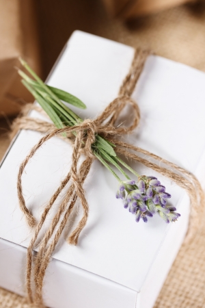 White Present box with rustic twine and sprig of lavender の写真素材