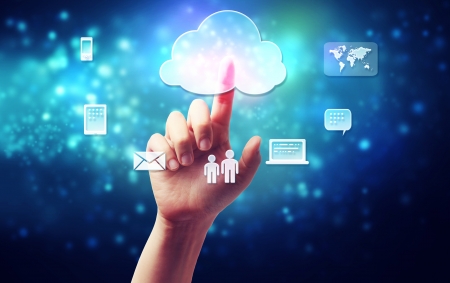 Cloud computing connectivity concept being pressed in a one persons hand on blue technology backgroundの写真素材