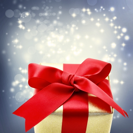 Golden present box with big red ribbon for Christmasの写真素材
