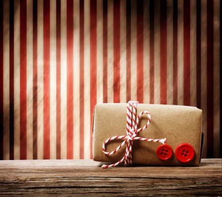 Handmade gift box with red twine cord over striped の写真素材