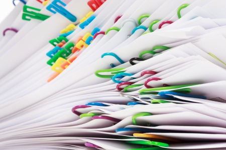 Pile of paper with colorful clipsの写真素材