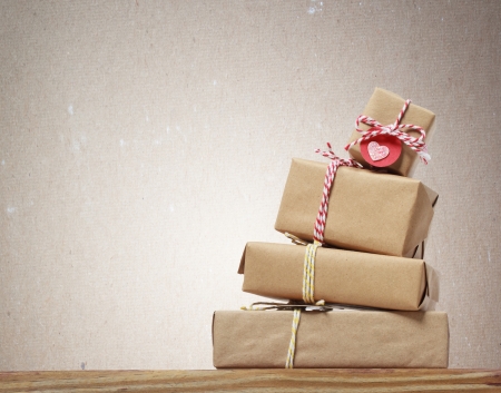 Stack of handcraft gift boxes on wooden board の写真素材