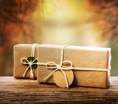 Handcrafted gift boxes with an autumn tree branch の写真素材