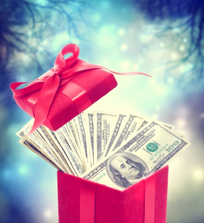 Hundred dollar bills in the red present box at magic nightの写真素材