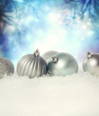 Silver Christmas baubles on the snow in the nightの写真素材