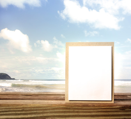 Handmade card on wooden table over blue sky backgroundの写真素材