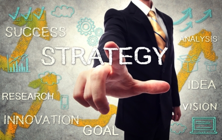 Businessman pointing STRATEGY with handwriting cartoonの写真素材