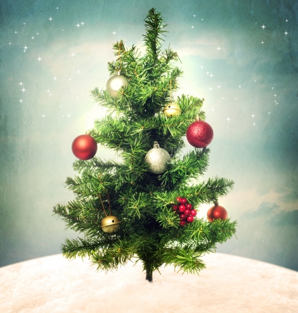 Decorated Christmas tree on a hilltop in the nightの写真素材