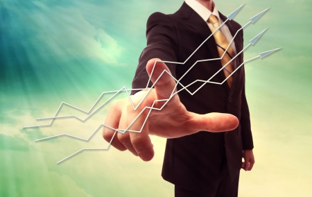 Businessman pointing arrows over turquoise sky backgroundの写真素材