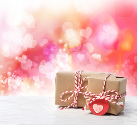 Small handmade gift boxes in pink hearts backgroundの写真素材